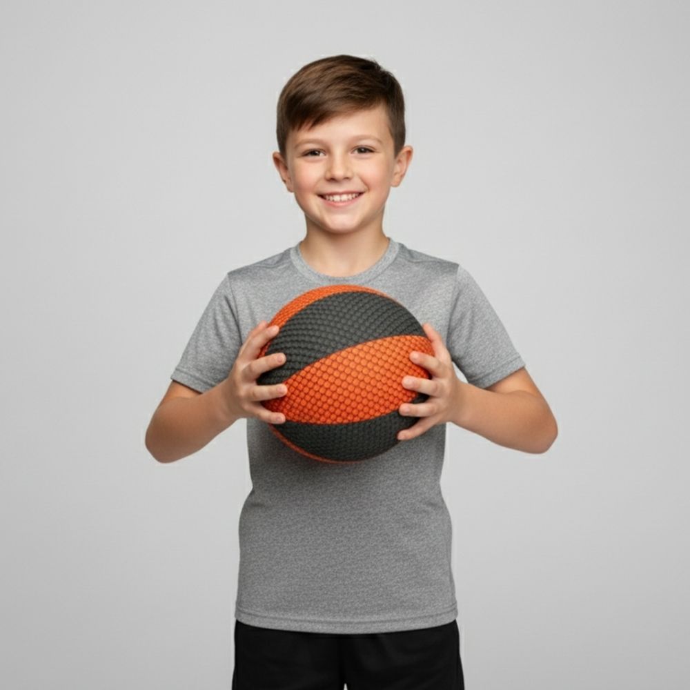 Child holding a HouseHoops Basketball against a gray background