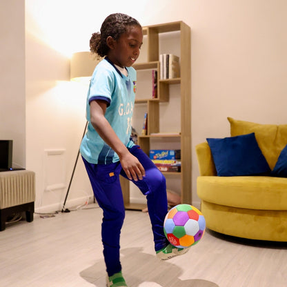 Child playing with The House Ball indoors.