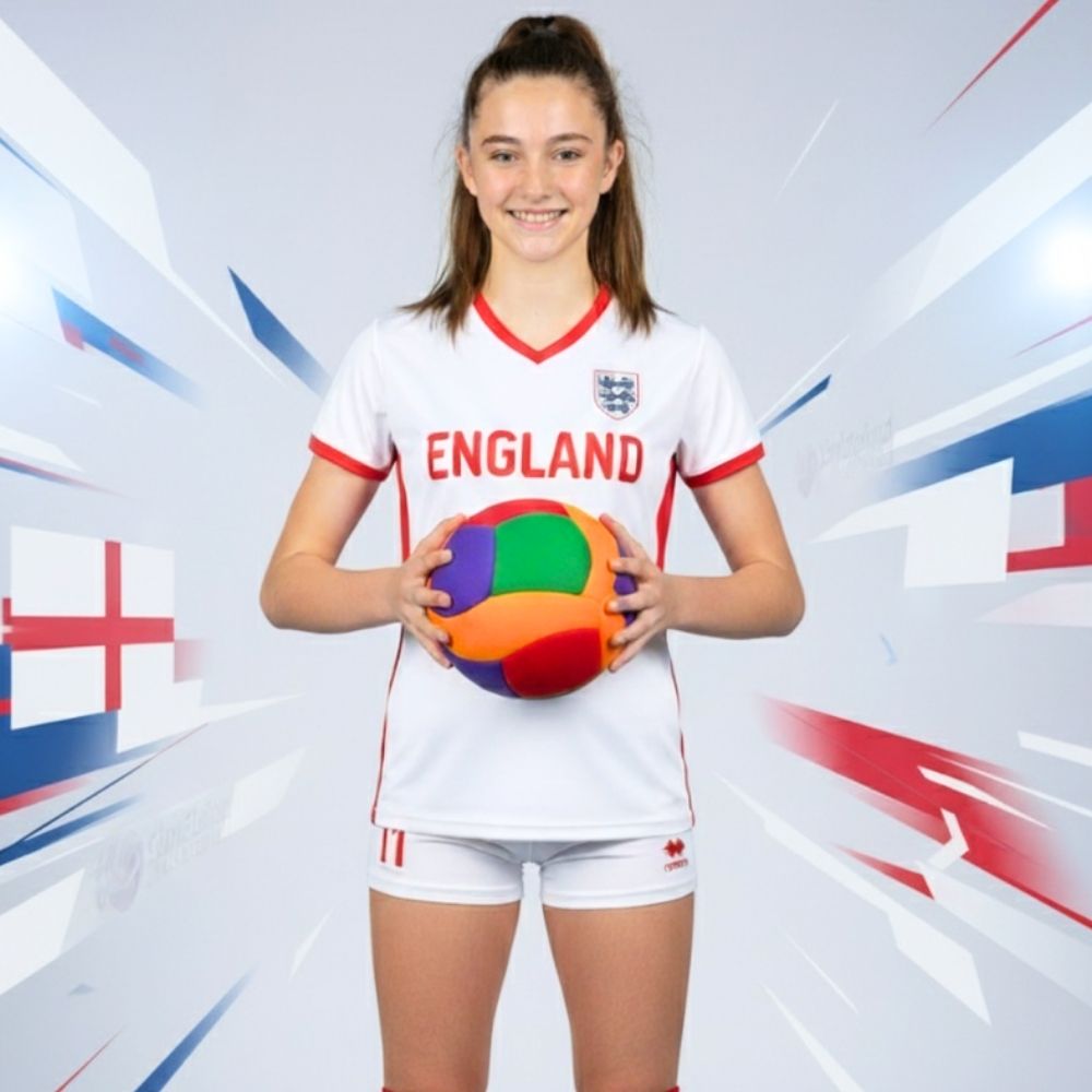 Person wearing an England sports jersey holding a Softy volleyball against a dynamic background