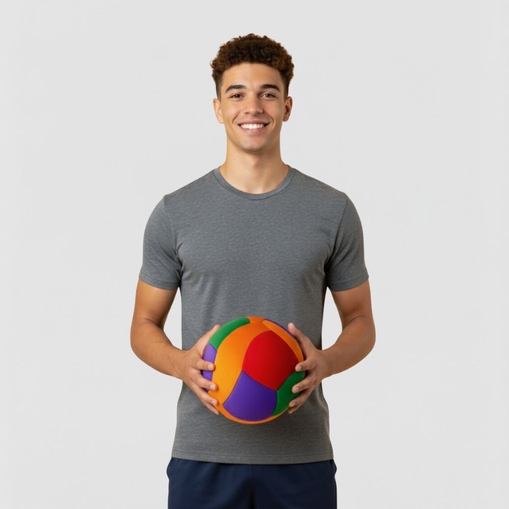 Man holding a Softy Volleyball against a plain background