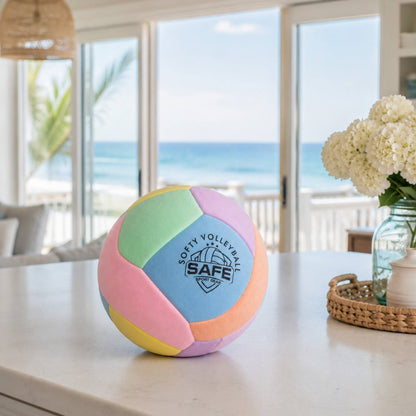 Softy Volleyball - Pink on a table with a beach view in the background
