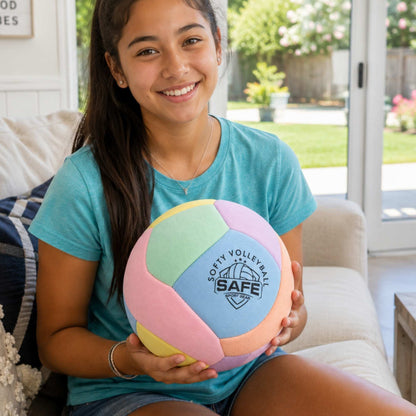 Girl holding a Softy Volleyball - Pink in a living room